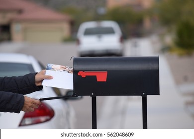 A Man Getting His Mail From His Mailbox.