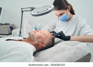 Man Getting Injection For Hair Growth In Cosmetology Clinic