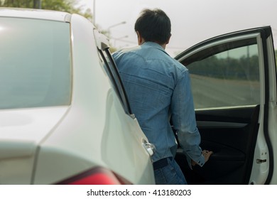 Man Getting Into Car