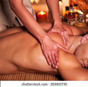 Man getting massage in spa. Female therapist.
