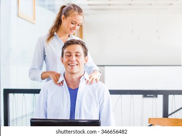 man getting massage while working in office