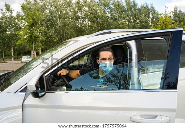 man getting out of car with\
mask
