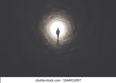 man getting out of a dark tunnel toward light
