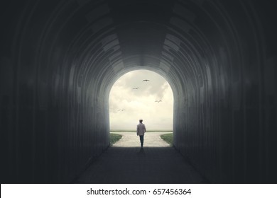 Man getting out from a dark tunnel