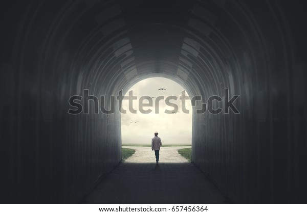 Man getting out from a\
dark tunnel