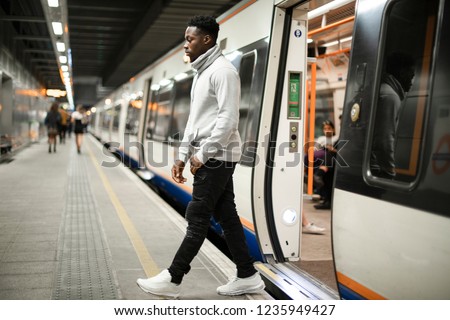 Man getting out of a subway train