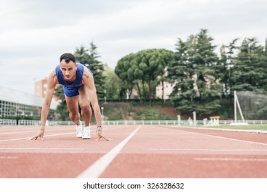 Man getting ready to start running on Stadium