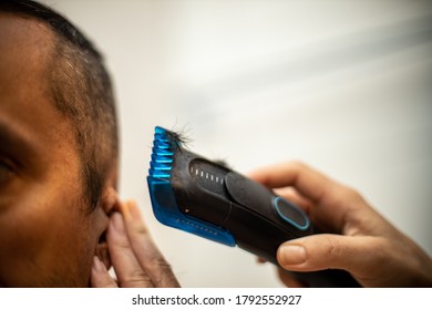 Man Getting A Self Haircut At Home