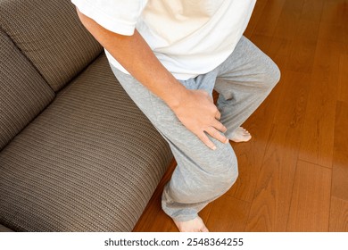 Man getting up from sofa