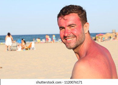 Man Getting Sunburned At The Beach