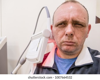 Man Getting Thermotherapy On Shoulder At Clinic