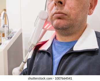 Man Getting Thermotherapy On Shoulder At Clinic