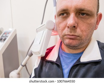 Man Getting Thermotherapy On Shoulder At Clinic