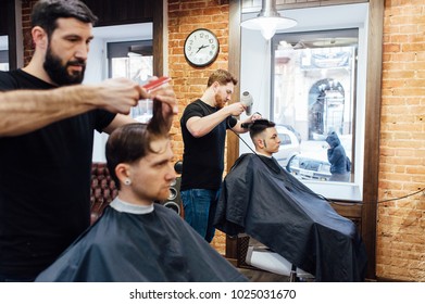 Man Getting Trendy Haircut At Barber Shop.