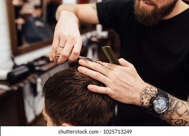 Man Getting Trendy Haircut At Barber Shop.