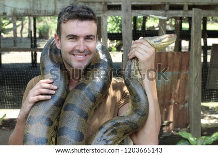Man with a giant Anaconda around his neck