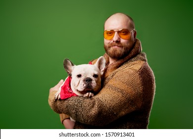 Man With Ginger Beard With French Bulldog In His Arms