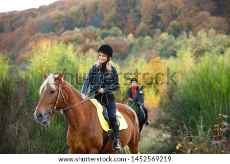 man and girl riding on separate  horses in mountains with amazing view. couple in love riding horses. professional jockeys. walk to remember on horses. couple equitation on black and brown horses. 