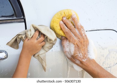 Man And Girl Washing Car  At Home. Cleaning Car. Closeup Hand Use Yellow Sponge Washing Car. Family Activity.