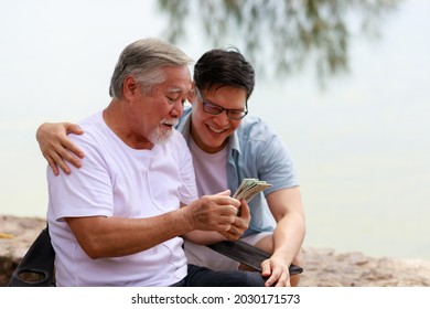 A Man Give Money To His Father.Financial And Saving Concept.