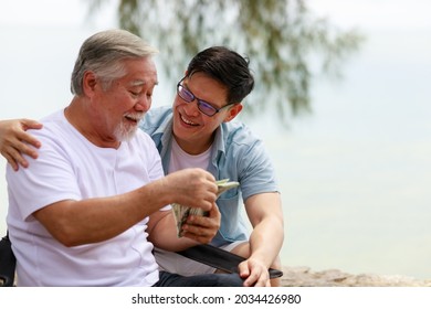A Man Give Money To His Father.Financial And Saving Concept.