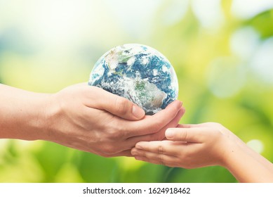 Man gives the Earth globe to the child. World environment day concept. Elements of this image furnished by NASA. - Shutterstock ID 1624918462