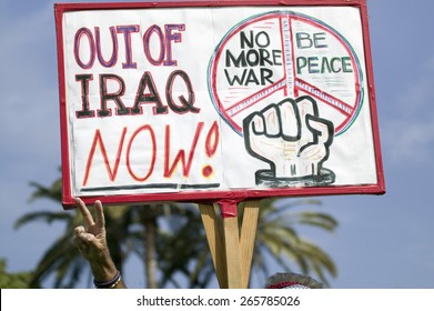 A Man Gives The Peace Sign And Holds A Sign Saying, 