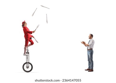 Man giving applause to an acrobat riding a giraffe unicycle and juggling isolated on white background - Shutterstock ID 2364147055
