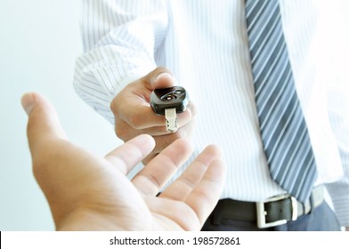 A man giving a car key - car rent & sale concept