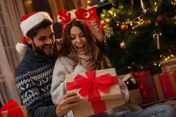 Man Giving A Christmas Present To His Girlfriend