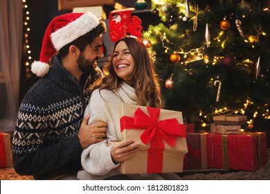 Man Giving A Christmas Present To His Girlfriend