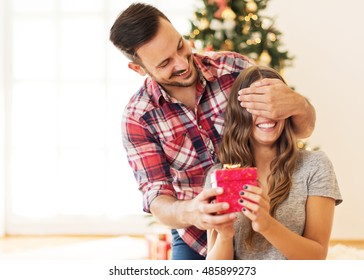 Man Giving A Christmas Present To His Girlfriend