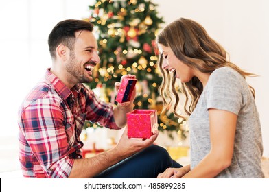 Man Giving A Christmas Present To His Girlfriend