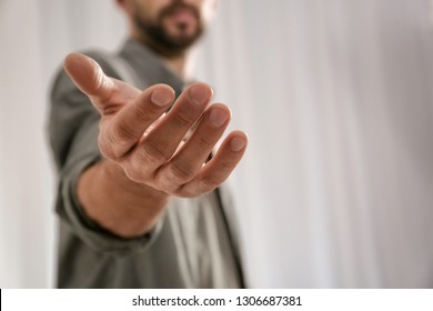 Man giving hand to somebody, closeup with space for text. Help and support concept - Shutterstock ID 1306687381