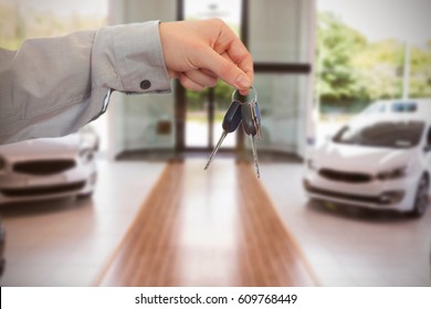 Man Giving Keys To Someone Against White Cars Parked