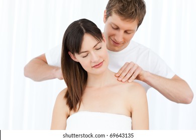 Man giving massage to his wife at home - Powered by Shutterstock