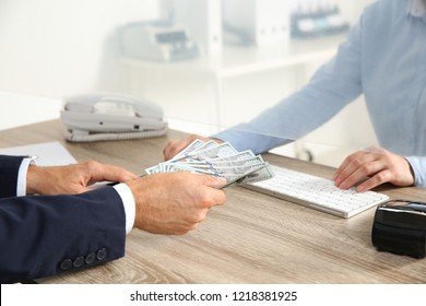 Man Giving Money To Teller At Cash Department Window, Closeup