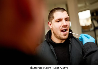 Man Giving A Saliva Sample For DNA Test During Police Investigation