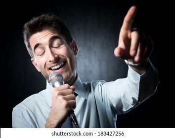 Man Giving A Speech With Microphone And Gesturing.