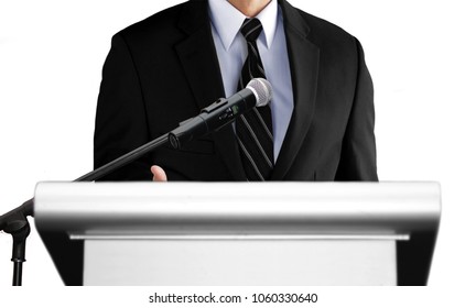 Man Giving Speech Using Microphone On Stage