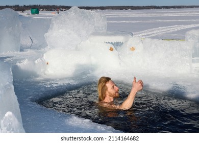 Man Giving Thumbs Up In Sun Swimming In An Ice Hole For A Cold Water Swim In Winter  At Kempenfelt Bay Lake Simcoe Barrie, Ontario, Canada - January 23, 2022