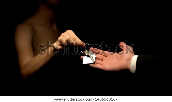 Man giving woman keys with house keychain,\
present for mistress,\
cheating