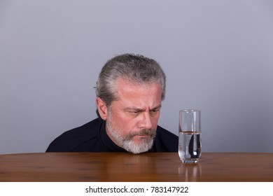 Man With Glass Half Full, Half Empty, Symbolic Image