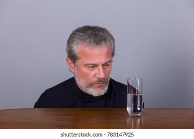 Man With Glass Half Full, Half Empty, Symbolic Image