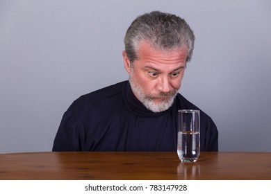 Man With Glass Half Full, Half Empty, Symbolic Image