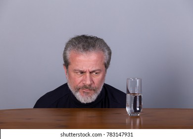 Man With Glass Half Full, Half Empty, Symbolic Image