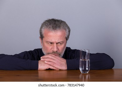 Man With Glass Half Full, Half Empty, Symbolic Image