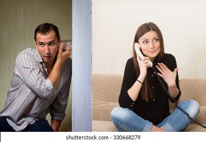 Man with a glass listening to the girl's phone conversation through the wall - Powered by Shutterstock