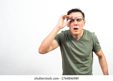 Man With Glasses Straining His Eyes Because He Can't See Well. Mid Shot. White Background.