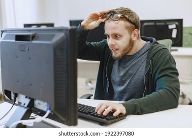 Man with the glasses. Student in computer science class. Person uses a computer. - Shutterstock ID 1922397080